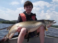 11 year old Thomas Bigot with a terrific pike of 1.24 metres estimated at 28 lb. + on Lough Derg