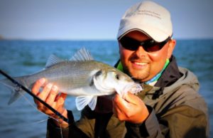 Bass fishing in Ireland A tanned Markus Muller with Bass