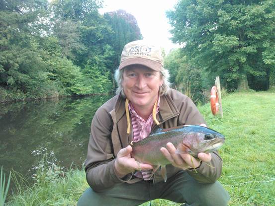 An angler with a fine rainbow trout taken on a Goldhead from the Sheetwater.