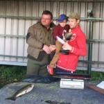 Kenny Kiernan holding his son being presented with the Sleator Cup by Jack Sleator