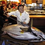 Kiyoshi Kimura, president of Kiyomura Co, poses with a bluefin tuna in front of his Sushi Zanmai restaurant in Tokyo (AP/Shuji Kajiyama)