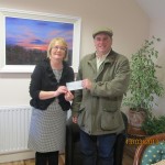 Garrett Ruigrok handing over cheque for €550 to Marie Peelo from Pieta House