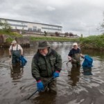 Jackie Owens and Mick and Jim Murphy cleaning up the River Burrin just a few weeks ago. The three were subjected to a vicious beating just a short distance from here