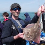 Thomas Mc Eleron shows off a Thornback Ray he got over slack water