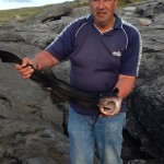 Mr Les Rixon with a massive 5.4Kg Bullhuss caught Shore Angling at Ballyreen, near Black Head, Co Clare.