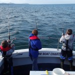 3 Young budding anglers bursting with enthusiasm for dogs