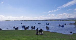 Boats heading out from the Carrick shore in very bright conditions at the start of the Corr na Mona Anglers competition for Galway Hospice