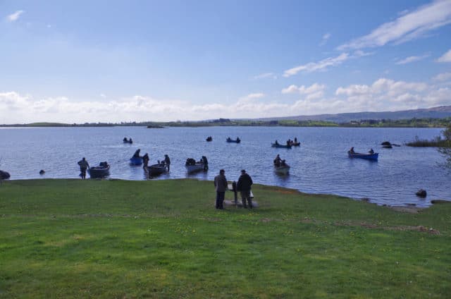 Boats heading out from the Carrick shore in very bright conditions at the start of the Corr na Mona Anglers competition for Galway Hospice