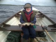 Champion Charlie tackles Lough Arrow Charlie Cooke (age 9) with a fine 1.5 lbs. trout on the dap from Lough Arrow