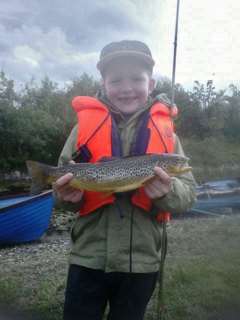 8 year old Cormac Murphy, from Coghans, with a nice trout he caught while fishing on Lough Conn with dad Adrian and brother Brendan