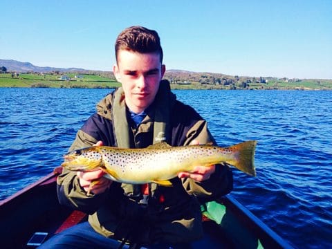 Eoghan Concannon with a trout he caught on a recent fishing trip