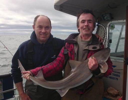 Kit Dunne congratulates Gar Murphy on his new Irish Record 19lb Smooth Hound.