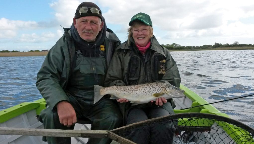 Denis in happier times with Sue Wherry and a fine Corrib trout on his beloved boat Sheelin Lady.