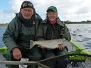 Denis says goodbye to Corrib Denis in happier times with Sue Wherry and a fine Corrib trout on his beloved boat Sheelin Lady.