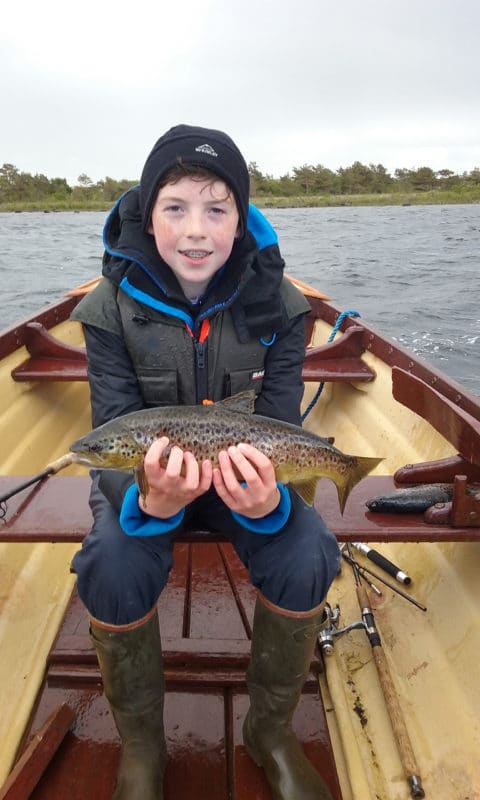 11 year old Luke Miller, from Dublin, with his fine 2.5lbs trout taken on the dap on Lough Mask while fishing with his uncle Declan.