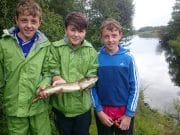 Three friends enjoy the fishing on Lough Oughter Jamie Smith with twins, Ben and Jack Mooney