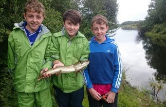 Three friends enjoy the fishing on Lough Oughter Jamie Smith with twins, Ben and Jack Mooney