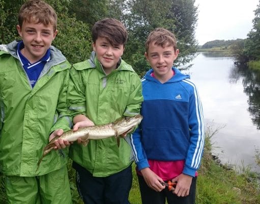 Three friends enjoy the fishing on Lough Oughter Jamie Smith with twins, Ben and Jack Mooney