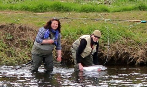 John Burgoyne Returns His Salmon as Glenda Looks on.
