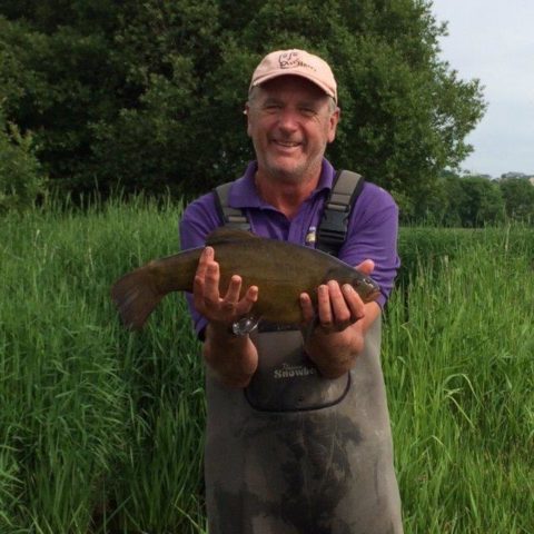 Harry with a nice Tench from his catch.
