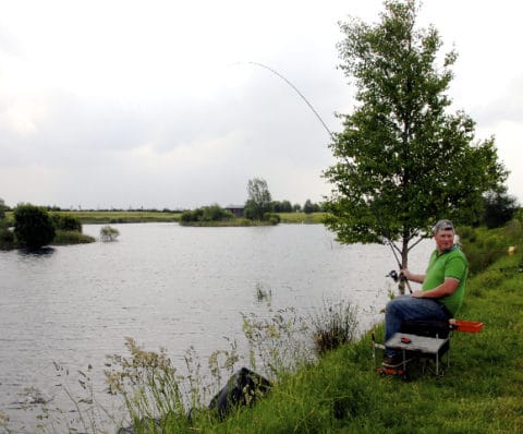 Liam Dillon enjoying playing a fish on Lough Aishling