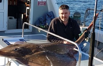 Angler poses with 210cm skate