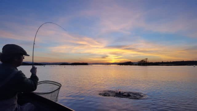 Playing a trout in the last light on Corrib. A wonderful shot from Larry McCarthy.