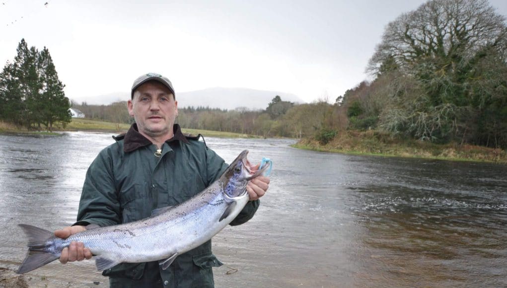 Eddie poses by the Drowes with his salmon