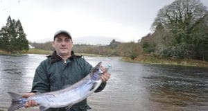 Eddie poses by the Drowes with his salmon