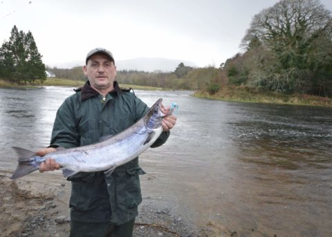 Eddie poses by the Drowes with his salmon