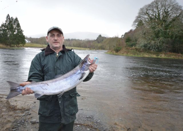 Eddie poses by the Drowes with his salmon
