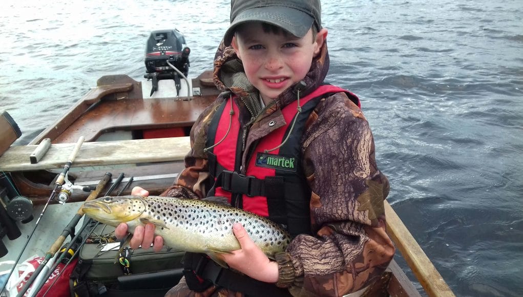 A young angler with his trout
