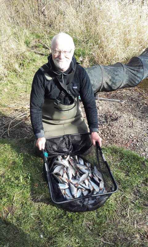 The winner poses with his catch