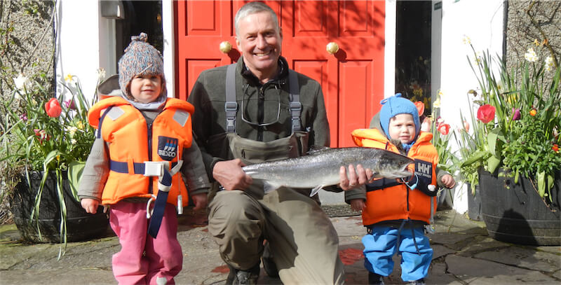 Dad and kids pose with salmon