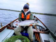 Liz gets Melvin's first fly caught salmon of season Angler poses in a boat with a salmon