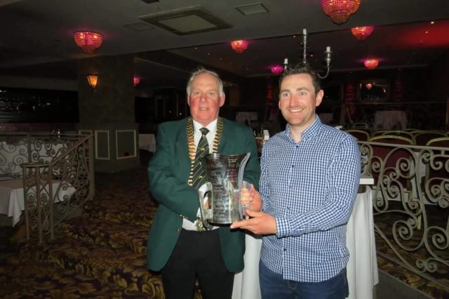 Winner Darren McGuire being presented with the trophy by Albert Berry
