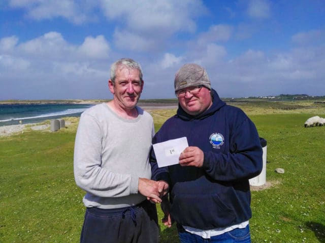 Aidan OHalloran, Winner of the 3rd leg of the Tubertini West Coast Shore League at Keel, receiving his prize from Padraic McKenna of host club Corrane SAC