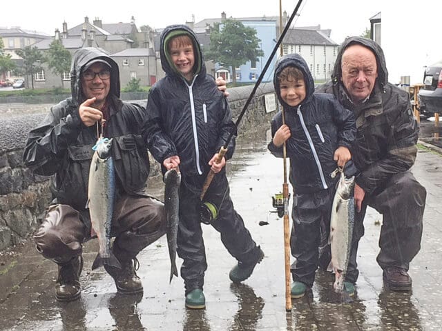 Three generations of the Cosgrove family - from left, Michael, with sons Blair & Conor with Grandad Henry, who enjoyed their day in the rain at the Galway Fishery!