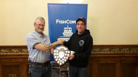 Gavin Dorrian with 14 species receives his winning prize from FishComm md Cormac Burke