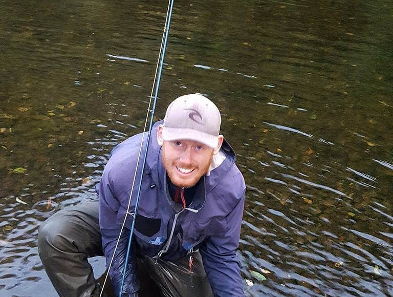 Jason Nash releasing a salmon
