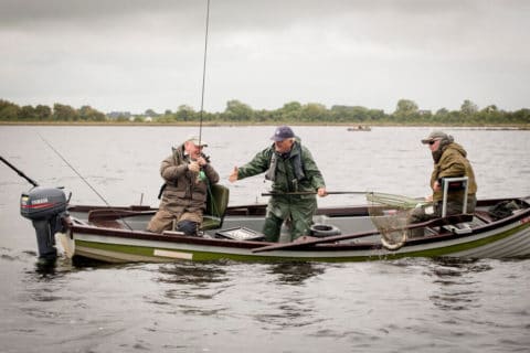 Well known angling guide Mick Dunne lands a fish for one of the competitors. Photo courtesy Conor Ledwith