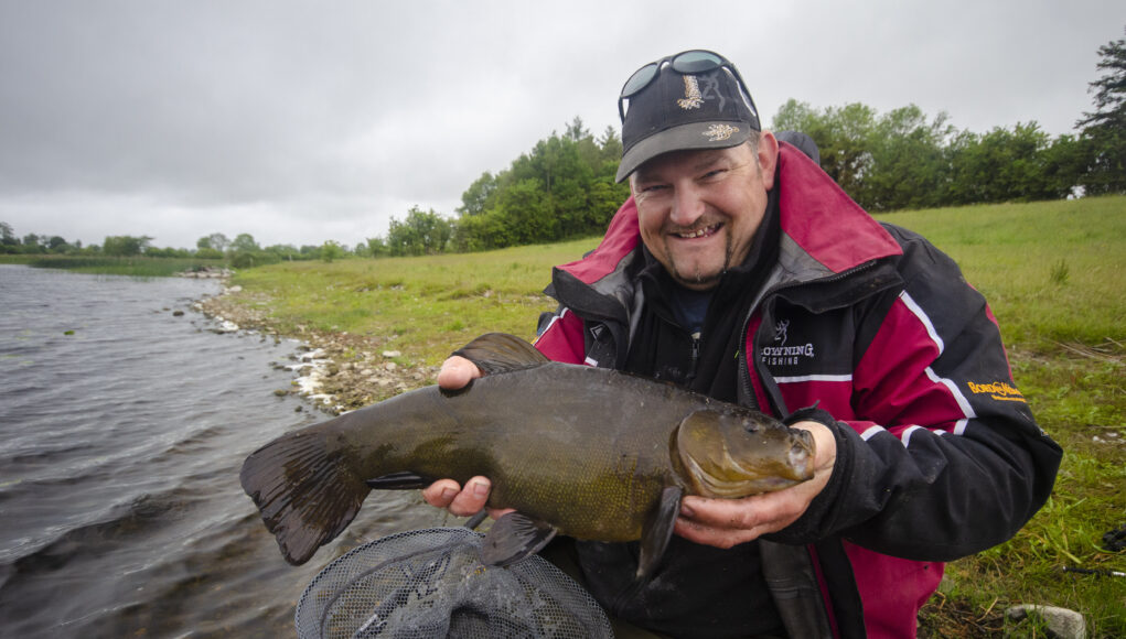 Angler with large tench