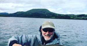 Storm Ellen fails to dampen spirits on Corrib Angler in boat on lake holding a very large trout.