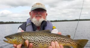 Up and down on Corrib – big fish for some anglers Angler in boat holding big trout