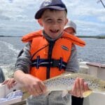 A delighted 7 year old David Black proudly shows his first Moy Estuary sea trout