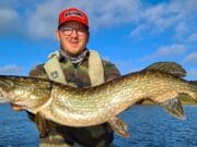 Angler holding large pike