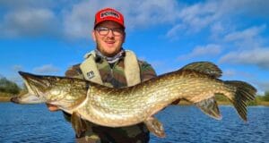 Angler holding large pike