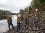 49 Seasonal Fisheries Officers to be recruited Four Fisheries Officers standing by a lake