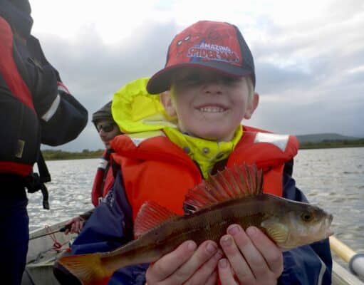 Young angler defies nasty weather to land a fine brace of perch