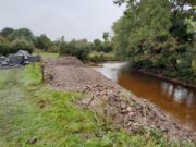 IFI secures prosecution and fines of €5,500 against farmer for riverbed destruction in Co Laois River to the right beside trees and to the left of the river there are piles of gravel that have been removed from the riverbed